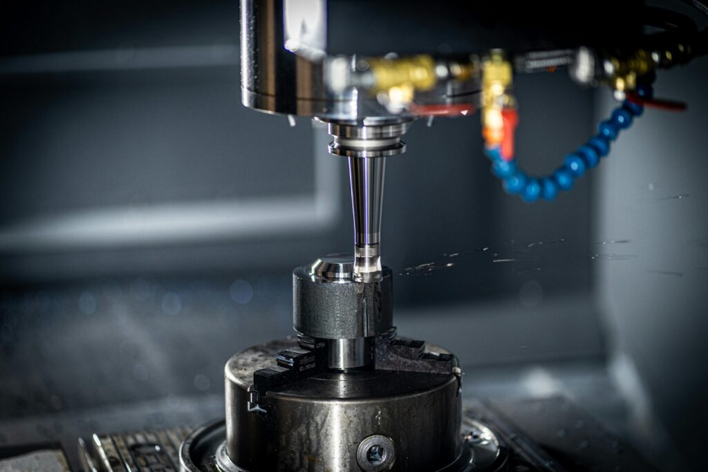 Close-up of CNC machine in action, showcasing precision engineering and industrial equipment.